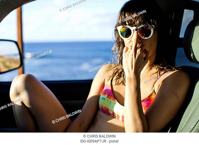 Woman in car by seaside