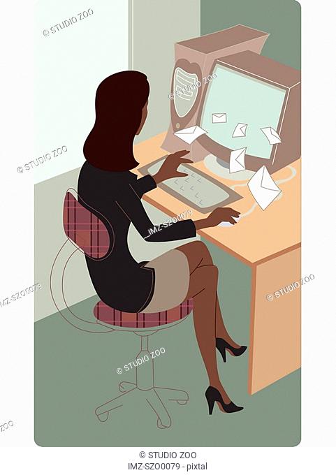 Businesswoman checking email at her desk