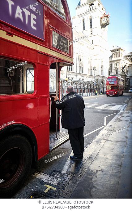 1958-1968 Routemaster buses. Conductor standing beside bus. The Strand, London, England