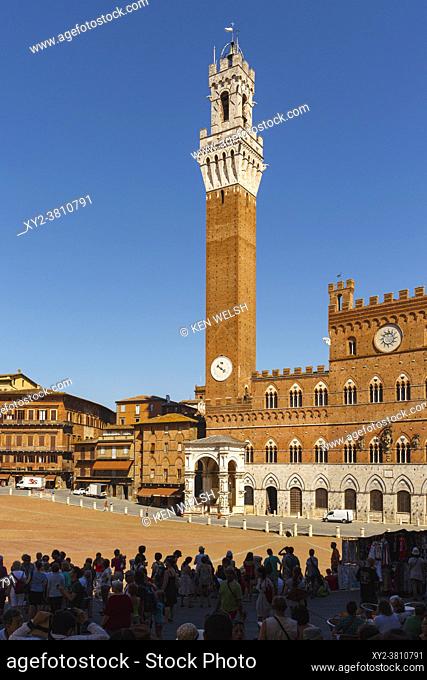 Siena, Siena Province, Tuscany, Italy. The Palazzo Pubblico with the Torre de Mangia seen across the Piazza del Campo