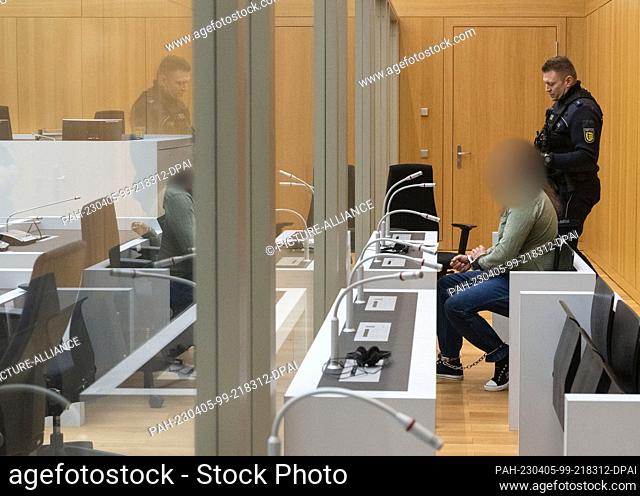 05 April 2023, Baden-Württemberg, Stuttgart: The defendant in a state protection case sits in a room of the Stuttgart Higher Regional Court