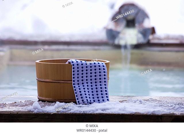 Hot spring and towel on wooden tub