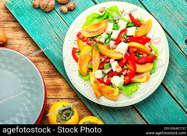 Fresh fruit salad with persimmons and cheese.Copy space