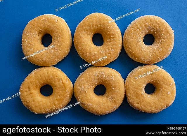 six doughnuts on blue background