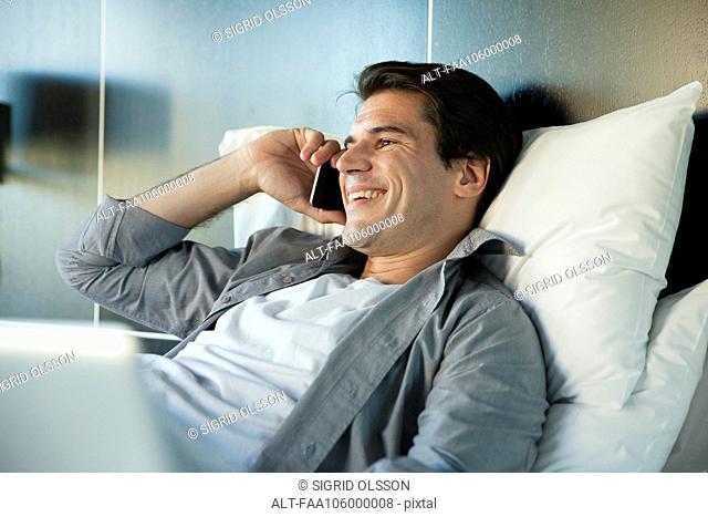 Man talking on cell phone, smiling cheerfully