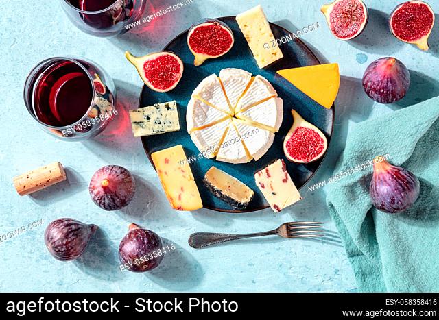 Cheese and wine tasting, cheese platter with figs, a flat lay, top shot