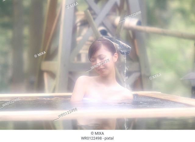 A young woman bathing in hot springs