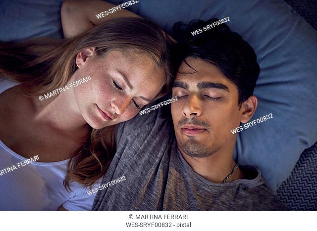 Young couple relaxing on cushions