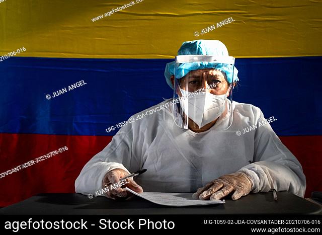 Health staff in charge of testing patients for the novel Coronavirus disease pose for a photo with Colombia's national flag on the background during the novel...