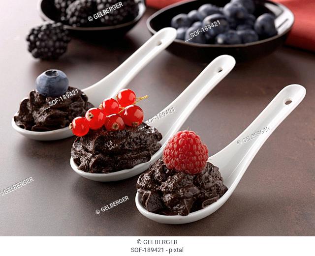 Spoonsful of chocolate mousse with summer fruit