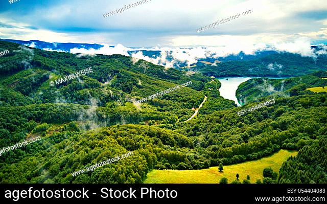 Clouds of fog after summer rain. Summer landscape with lake and mountain woodland. Aerial view of Reservoir/lake Starina, Poloniny national park, Slovakia