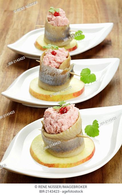 Rolled soused herring on apple slice with cranberry horseradish filling