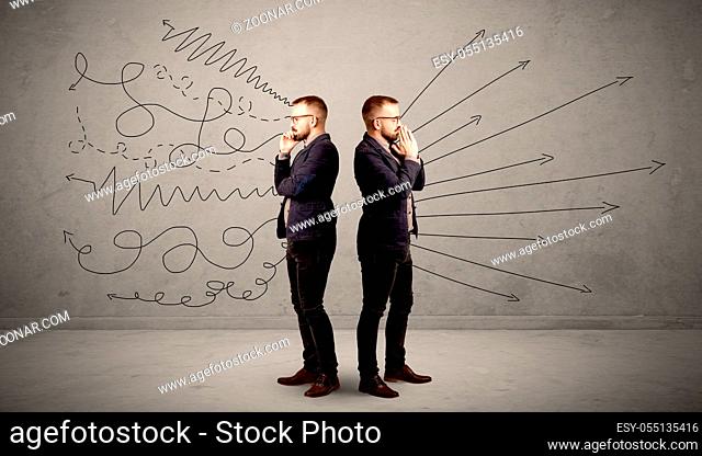 Young conflicted businessman choosing between two directions with arrows and scribbles around him