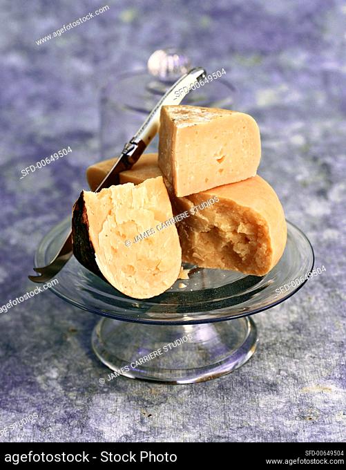 Still Life of Hard Cheeses on a Glass Pedestal Dish