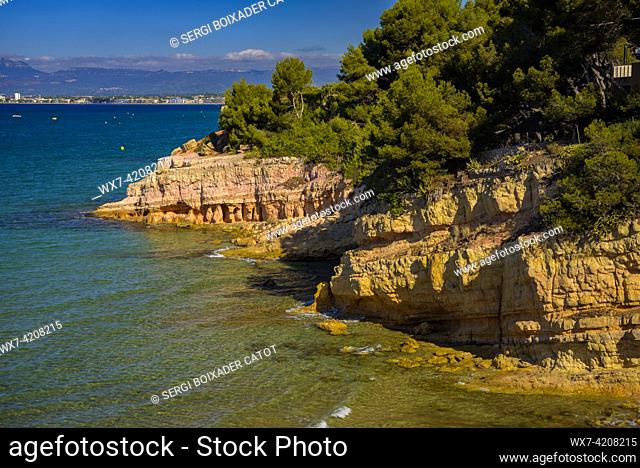 View of the Cala de la Penya Tallada cove and its cliffs and surrounding forest in Salou, on the Costa Daurada coast (Tarragona, Catalonia, Spain)