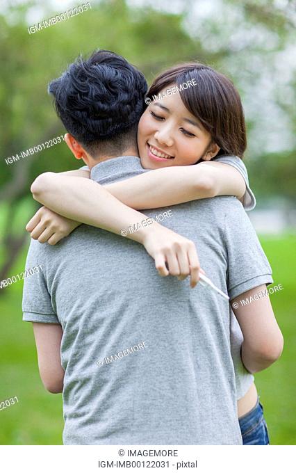 Young couple embracing with smile