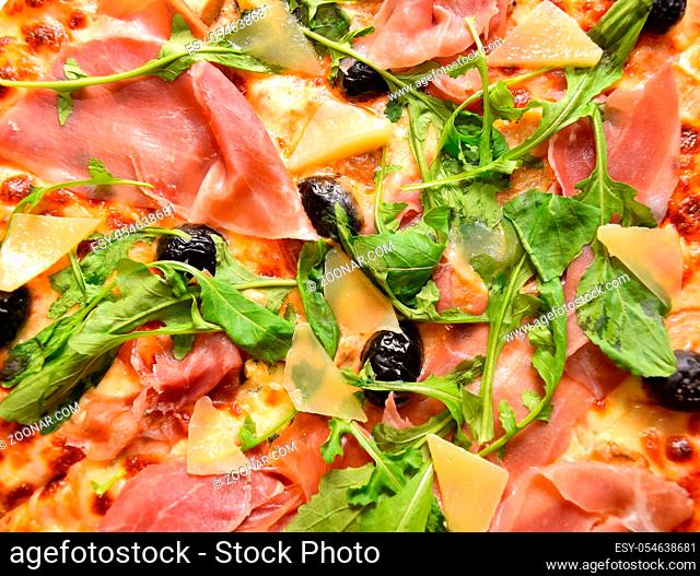 italian fast food pizza with ham cheese and arugula