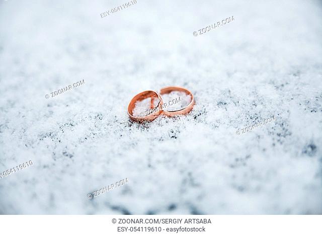 Beautiful Wedding rings on the snow. Soft focus