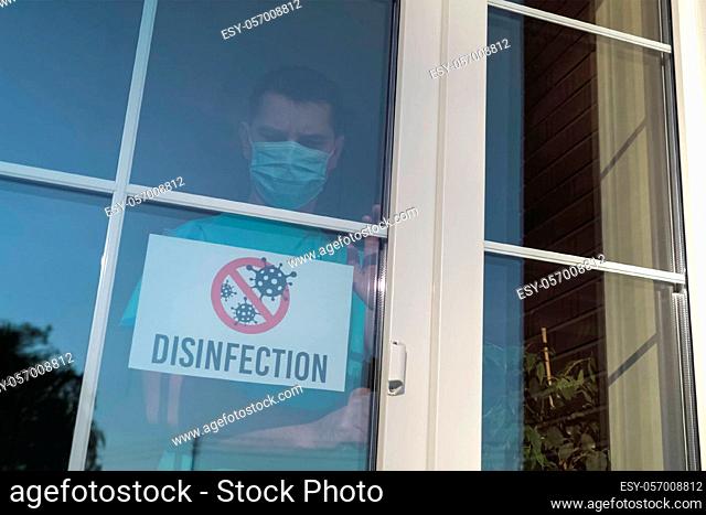 DISINFECTION sticker. Owner of the institution glues a sign with the word DISINFECTION and close door during a coronavirus pandemic