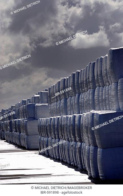 Stacked silage bales wrapped in plastic for a rural biomass gasifier