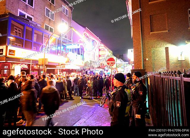 01 January 2023, Hamburg: Police officers patrol the Grosse Freiheit on New Year's Eve in the St. Pauli district. Photo: Marcus Brandt/dpa