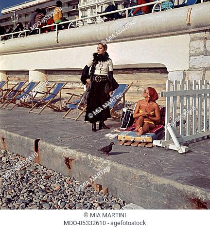 The singer Mia Martini (Domenica Rita Adriana Bertè) beside a woman in swimsuit. Nice, France. 1971