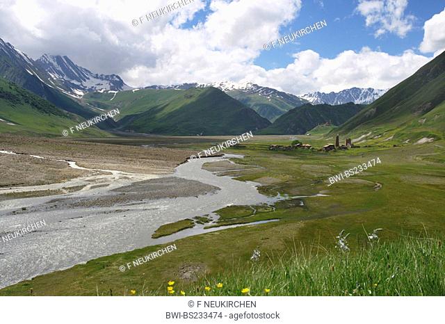 wide valley with a river, an abandonned village and a mediaeval fortress in front of mountain panorama, Georgia, Truso-Tal