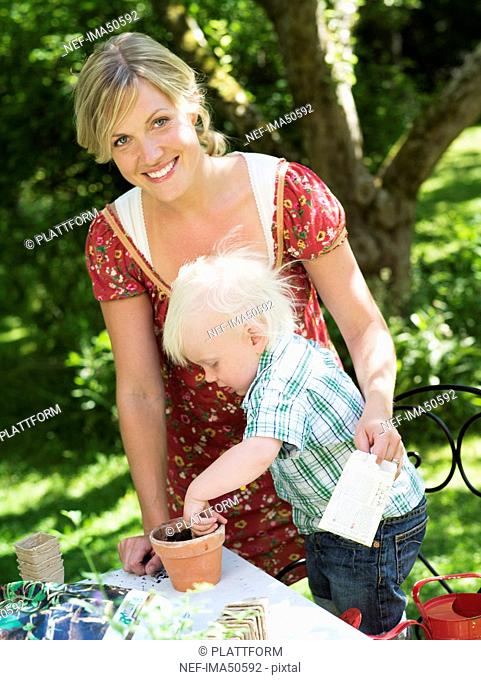 Mother and son planting seed, Stockholm, Sweden