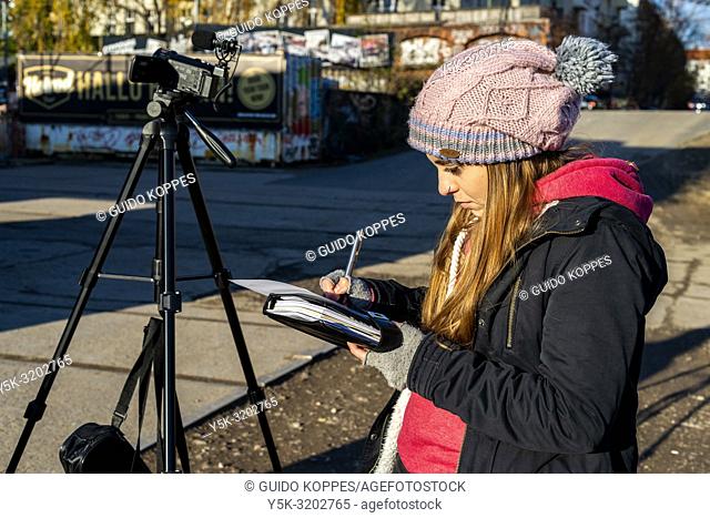 Berlin, Germany. Young, Brazilian girl filming RAW-Gelande, a creative and urban hotspot onside former Eastern Berlin for her Youtube Chanel