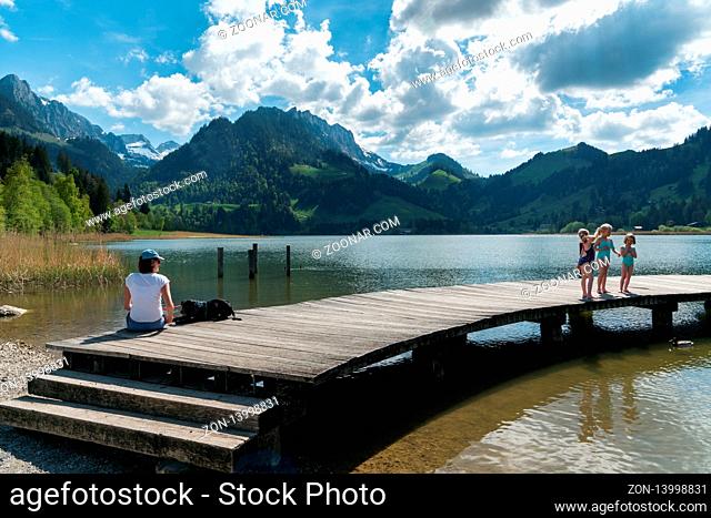 Schwarzsee, FR / Switzerland - 1 June 2019: tourist people enjoy a visit to Lake Schwarzsee in Fribourg as a family vacation destination in the Swiss Alps