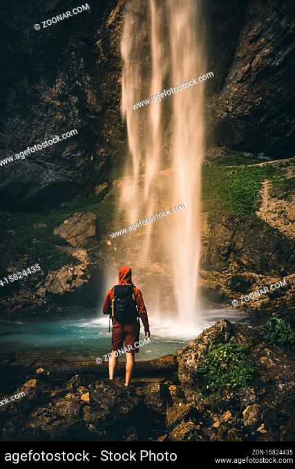 Man standing near big Waterfall in Austria in Summer - Wildensteiner Waterfall in Carinthia