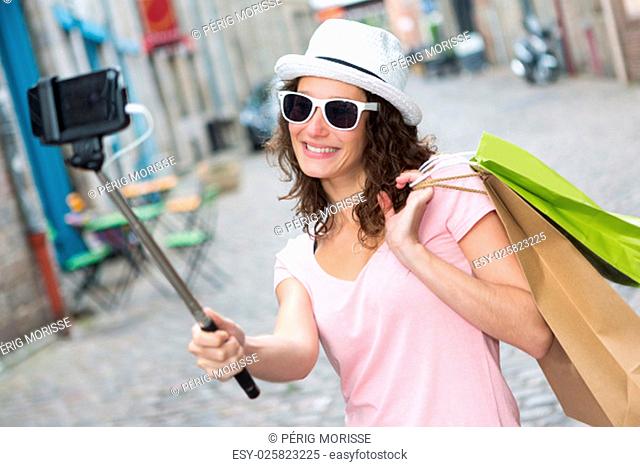 View of a Young attractive woman taking selfie while shopping