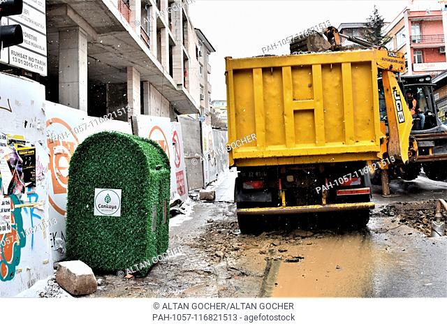 17 January 2019, Turkey, Ankara: A garbage can with a green eco-friendly design is placed next to the construction site of a building by the main opposition...