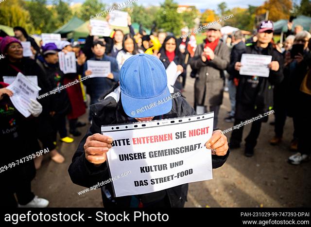 29 October 2023, Berlin: A person holds a sign during a rally for the preservation of the Thai market in the Prussia Park of the ""Thai Association in Berlin""...