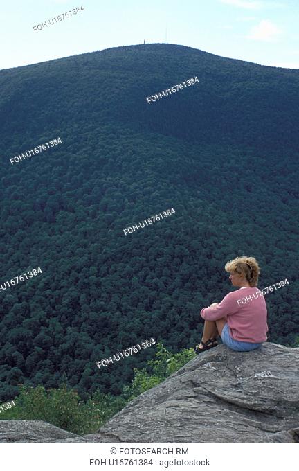 Taconic Range, North Adams, MA, Massachusetts, Mt. Greylock, Woman sitting a overlook on the summit of Mount Greylock looking out at Taconic Range from Mount...