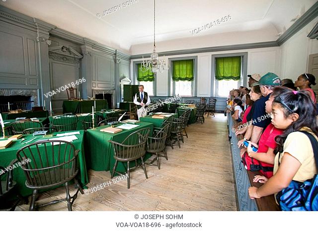 US students in the Assembly Room where Declaration of Independence and U.S. Constitution were signed in Independence Hall, Philadelphia, Pennsylvania