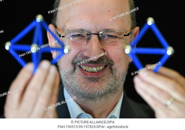 13 May 2019, Hessen, Gießen: Albrecht Beutelspacher, director of the interactive museum ""Mathematikum"", presents in a special exhibition two octahedrons that...
