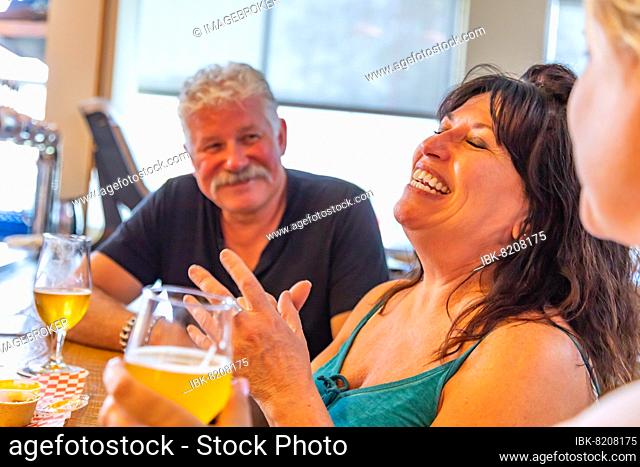 Group of friends enjoying glasses of micro brew beer at bar