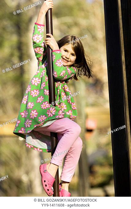 Young girl sliding on pole at playground - Franklin Park - Brevard, North Carolina