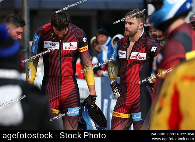 08 January 2023, North Rhine-Westphalia, Winterberg: Bobsleigh: World Cup, four-man bobsleigh, men, 2nd run: Tobias Schneider (r) and his team from Germany show...