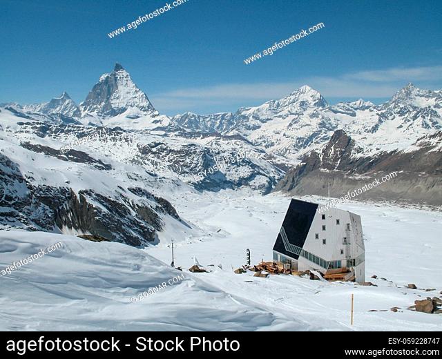 view of the Monte Rosa mountain hut and Gorner Glacier with the Matterhorn behind in the Valais region of Switzerland