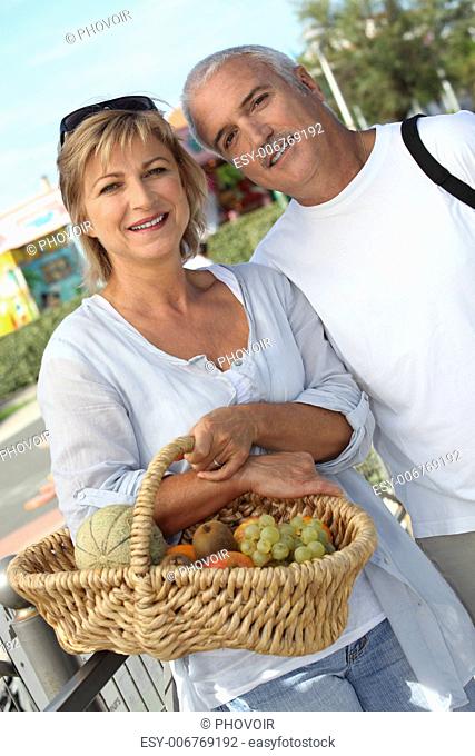 Couple with basket of fruit