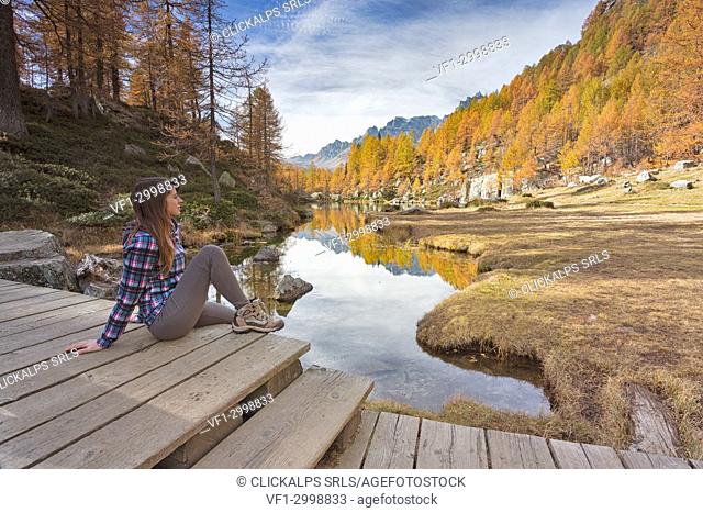 A woman staring at the small lake near Crampiolo known as Witches Lake, Alpe Veglia and Alpe Devero Natural Park, Baceno, Verbano Cusio Ossola province