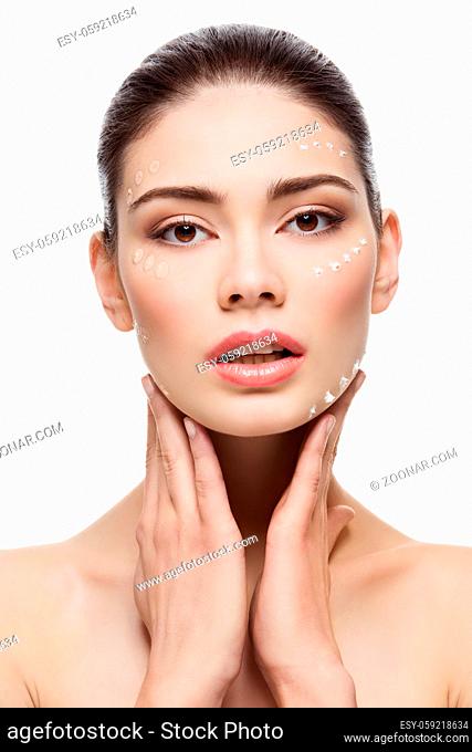 Beautiful young woman with foundation cream on face. Beauty shot. Isolated over white background. Copy space