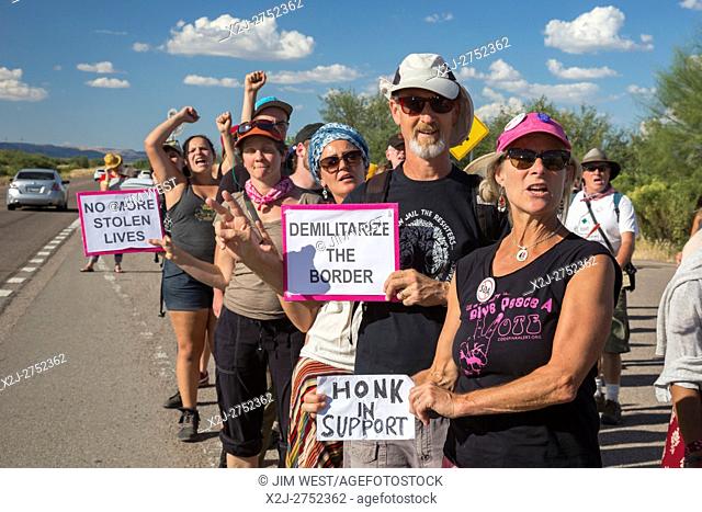 Tubac, Arizona - 9 October 2016 - Immigration reform activists march through the Border Patrol checkpoint on Interstate 19