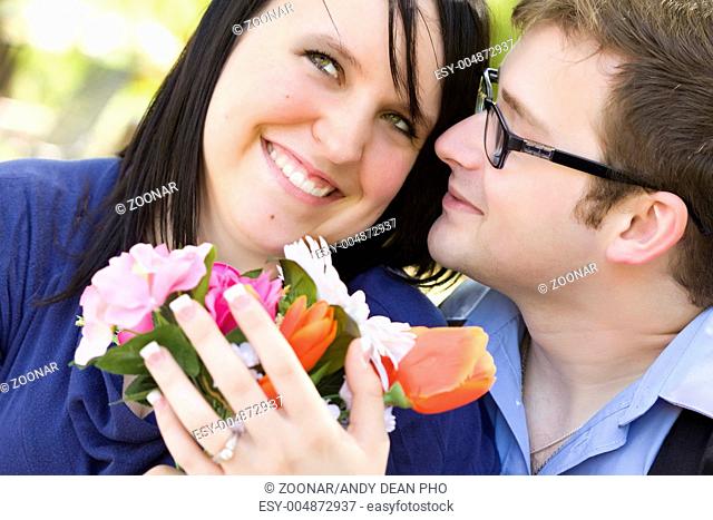 Attractive Young Man Gives Flowers to His Love