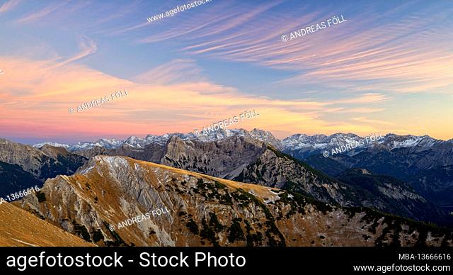 Autumn mountain landscape after sunset in the Ammergau Alps. In the background the Zugspitze and the Mieminger chain. Bavaria, Germany, Europe