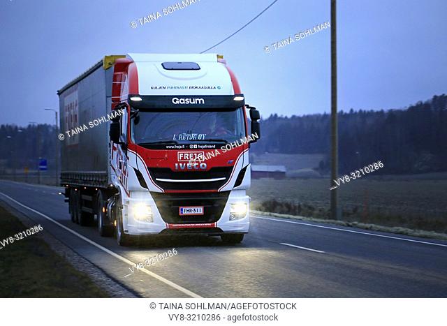 Salo, Finland - December 16, 2018: Biogas fueled Iveco Stralis NP truck L. Retva Oy pulls FREJA freight trailer along highway on a dark, cloudy winter evening