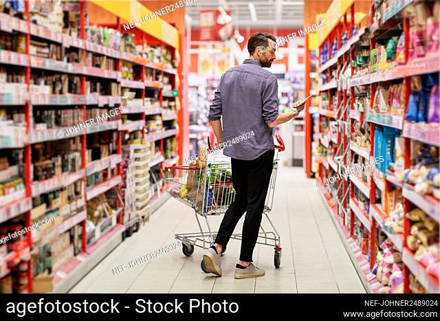 Man doing shopping in supermarket