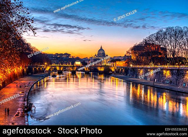 Dramatic sunset over the St. Peters Basilica and the river Tiber in Rom